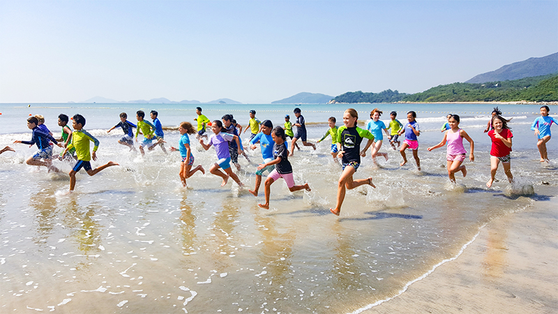 Hong Kong green school Lantau International School - students on beach