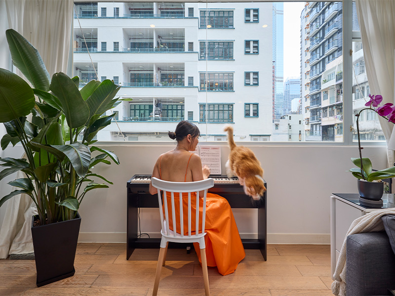 Professional organiser Marianne Obena at home with her cat in Soho