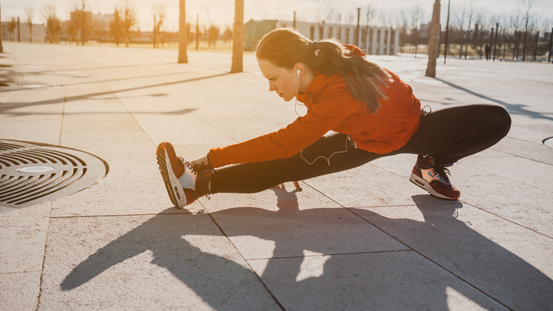 Woman stretching - for interview with Hong Kong cardiologist Dr Arthur Yung on running and heart health