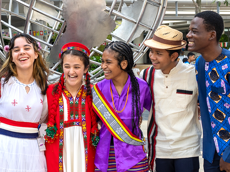 Singapore international schools students in traditional dress - UWCSEA, relocating to Singapore